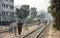 Dhaka, Bangladesh: A group of people walk along the railway tracks