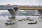 Dhaka, Bangladesh - July 4, 2011: Urban traffic, traffic jam on the bridge, boats on the river carrying passengers using paddle, D