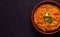 Dhal Indian vegetarian lentil bean soup with herbs close-up on a dark background. copy space