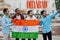 Dhanbad city inscription. Group of four indian male friends with India flag making selfie on mobile phone. Largest India cities