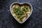 Dhokla in a heart shaped bowl with gray granite background