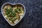 Dhokla in a heart shaped bowl with gray granite background