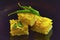 Dhokla Indian dish with chili on a black background