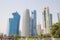 A dhow passes beneath some of the most massive buildings in Doha, Qatar, shortly before sunset.