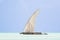 Dhow wooden boat with sail in a tropical clear blue sea at the Indian Ocean