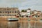 Dhows and boats moored at shore against buildings in Shela Beach, Lamu Island, Kenya