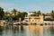 Dhows and boats moored at shore against buildings in Shela Beach, Lamu Island, Kenya