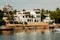 Dhows and boats moored at shore against buildings in Shela Beach, Lamu Island, Kenya