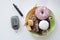 Diabetes concept: sweets and unhealthy food with glucometer. Nutrition cause diabetic desease