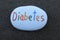 Diabetes disease word painted on a stone