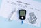 Diabetes glucose meter for diagnosis lancet syring and pills on blood sugar level log top view