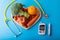 Diabetes monitor, diabetic measurement. World diabetes day concept with clean fruits in nutritionist`s heart dish..Healthy food or