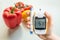 Diabetic diet, diabetes and healthy eating concept. Glucometer and vegetables.