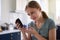 Diabetic Girl At Home Testing For Blood Glucose Level With Monitor Kit In Kitchen