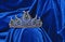 Diadem with green stones on a blue velvet background. Eastern tiara. Jewelry design