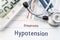 Diagnosis Hypotension. Stethoscope, hematology blood test result and digital tonometer lie on sheet of paper with printed title di