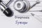 Diagnosis of Syncope. Medical doctor`s statement with diagnosis Syncope is on neurologist workplace, which are stethoscope, hammer