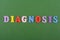 DIAGNOSIS word on green background composed from colorful abc alphabet block wooden letters, copy space for ad text