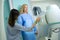 Diagnostic radiographer preparing adult woman for radiography