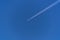 Diagonal airplane trace on a clear blue sky