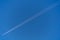 Diagonal airplane trace on a clear blue sky