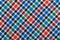 Diagonal Checkered plaid fabric background. Texture of red blue green plaid fabric
