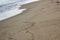 Diagonal close up of soft sea wave and beach sand