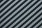 Diagonal close-up of striped ribbed metal surface