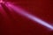 Diagonal diffused gradient pink beam of light on a dark red structural background