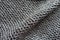 Diagonal fold on greyish brown wool