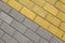 Diagonal grey and yellow paving slabs top view. Bricks as street road, paving stone texture. Abstract paving stone