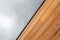 Diagonal line modern architecture detail, red cedar wood cladding and copy space sky background