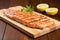 diagonal lined grill marked salmon steak on a wooden board