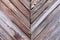 Diagonal lined wood barn door wall siding with visible nails weathered