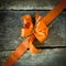 Diagonal orange ribbon on wood