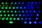 Diagonal RGB gaming keyboard bokeh background. Colorful mechanical keyboard in dark room. Gaming and technology concept