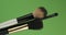 Diagonal rotation of the makeup brushes set. Isolated on green.