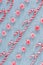 Diagonal rows of Christmas candy canes and peppermint swirl candies flay lay arrangement