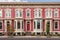 a diagonal shot of italianate facade with rounded windows