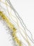 Diagonal. Silver and golden chain with balls, beads, yellow tinsel. New year decorations on a white background. Christmas concept.