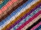 Diagonal stripes of crocheted stitches in multi-coloured wool ba