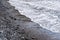 diagonal view of a dark sandy beach