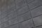 Diagonal view of smooth gray rectangular tile on wall, for background or design