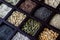 Diagonal view of a wooden box filled with compartments of grains and seeds.