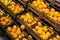 Diagonal view of wooden lug boxes with ripe lemons on counter in supermarket