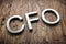 Diagonal white 3d letters CFO on wooden planks