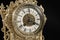 Dial of vintage bronze clock, antique clock photo close up, old bronze clock in gilding,