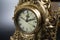 Dial of vintage bronze clock, antique clock photo close up, old bronze clock in gilding, front of bronze fireplace clock