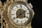 Dial of vintage bronze clock on black background, antique clock photo close up, old bronze clock in gilding,