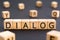 Dialog - word from wooden blocks with letters